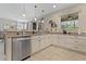 Modern kitchen featuring granite countertops, stainless steel appliances, and neutral colors at 10136 Grand Oak Cir, Madeira Beach, FL 33708
