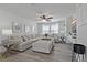 Well-lit living room features comfortable seating, contemporary decor, and large windows at 10136 Grand Oak Cir, Madeira Beach, FL 33708