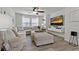 Bright living room with plush sectional sofa, large windows, and modern entertainment center at 10136 Grand Oak Cir, Madeira Beach, FL 33708