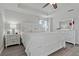 Spacious main bedroom showcasing a tray ceiling, ceiling fan, and light hardwood-style flooring at 10136 Grand Oak Cir, Madeira Beach, FL 33708