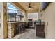 Entertain in this outdoor kitchen with stone bar, grill, beverage cooler and tv at 10136 Grand Oak Cir, Madeira Beach, FL 33708