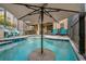 Stunning outdoor pool with a built-in umbrella stand for shade at 10136 Grand Oak Cir, Madeira Beach, FL 33708