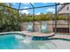 Inviting screened pool area featuring a waterfall feature and comfortable seating at 10136 Grand Oak Cir, Madeira Beach, FL 33708