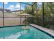 Refreshing swimming pool with a centrally located umbrella stand at 10136 Grand Oak Cir, Madeira Beach, FL 33708