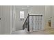 A bright staircase features a decorative iron railing and natural light from a nearby window at 10136 Grand Oak Cir, Madeira Beach, FL 33708