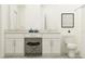 Bright bathroom showcasing double vanity with granite counters, stool, framed art, and toilet at 10807 Fort White Ct, Tampa, FL 33647