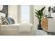 Bright bedroom features a bed with decorative pillows and a stylish white and wood nightstand at 10807 Fort White Ct, Tampa, FL 33647
