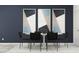 A modern dining room with six chairs, a white table, and contemporary art on the wall at 10807 Fort White Ct, Tampa, FL 33647