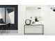Bright hallway featuring modern console table with decorative objects and artwork at 10807 Fort White Ct, Tampa, FL 33647