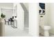 Hallway with a staircase, dining table, and a half bathroom with a toilet and mirror at 10807 Fort White Ct, Tampa, FL 33647