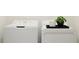 Close-up of new white washer and dryer with decorative plant in the laundry room at 10807 Fort White Ct, Tampa, FL 33647