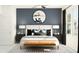 Stylish main bedroom with a plush bed, modern decor, and natural light from large windows at 10807 Fort White Ct, Tampa, FL 33647
