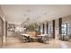 Bright dining area features modern tables and chairs, complemented by stylish pendant lighting at 11870 Sparkling Topaz Cv, Parrish, FL 34219