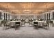 Spacious event space showcasing elegant chandeliers, round tables with seating, and a neutral color scheme at 11870 Sparkling Topaz Cv, Parrish, FL 34219