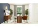 Bright home office features stylish desk, comfortable chairs, ample natural light, and decorative plants at 11870 Sparkling Topaz Cv, Parrish, FL 34219