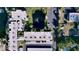 Aerial view of a condo complex with a pond, fountain, and covered parking at 11945 143Rd St # 7122, Largo, FL 33774