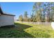 Spacious backyard with a well-maintained lawn, perimeter fence and wooded area at 12593 Palapa Loop, Spring Hill, FL 34610