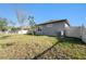 A view of the exterior showing well-maintained grass and privacy fence at 12593 Palapa Loop, Spring Hill, FL 34610