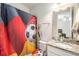 Bathroom featuring soccer themed decor, granite counters, and a sink at 12593 Palapa Loop, Spring Hill, FL 34610