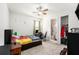Cozy bedroom with ceiling fan, carpet flooring, a desk, and closet access at 12593 Palapa Loop, Spring Hill, FL 34610