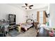 Bedroom features a ceiling fan, a mounted TV, and a large shelving unit at 12593 Palapa Loop, Spring Hill, FL 34610