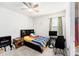 A simple bedroom with a ceiling fan, carpet flooring, and natural light at 12593 Palapa Loop, Spring Hill, FL 34610