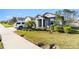 Landscaped single-story home features a well-manicured lawn, an attached garage, and a neutral exterior paint scheme at 12593 Palapa Loop, Spring Hill, FL 34610