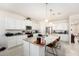 Bright kitchen features white cabinets, stainless steel appliances, granite countertops, and a large central island at 12593 Palapa Loop, Spring Hill, FL 34610
