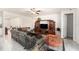 Open-concept living room with tile floors, neutral walls, a ceiling fan, and comfortable seating at 12593 Palapa Loop, Spring Hill, FL 34610