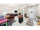 Bright living area with tile floors, neutral walls, a decorative front door, and large windows for natural light at 12593 Palapa Loop, Spring Hill, FL 34610