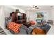 Living room features tile floors, neutral walls, a ceiling fan, sliding glass doors, and comfortable seating at 12593 Palapa Loop, Spring Hill, FL 34610