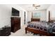 Primary bedroom features a ceiling fan, large window, and classic furnishings at 12593 Palapa Loop, Spring Hill, FL 34610