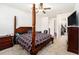Primary bedroom features a ceiling fan, large window, and classic furnishings at 12593 Palapa Loop, Spring Hill, FL 34610