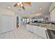 Bright kitchen boasts white cabinetry, stainless steel appliances, granite counters, and an open design at 13024 Prestwick Dr, Riverview, FL 33579