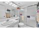 Well-lit bathroom featuring a shower with glass doors, a white vanity, and modern fixtures, offering a clean and functional space at 1424 Pine Glen Ln # B2, Tarpon Springs, FL 34688