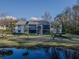 Exterior view of condo building with pond view, highlighting its well-maintained landscaping and building facade at 1424 Pine Glen Ln # B2, Tarpon Springs, FL 34688