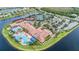 Aerial view of Valencia Lakes community featuring tennis courts, clubhouse, pool, and lake at 16112 Amethyst Key Dr, Wimauma, FL 33598