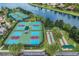 Aerial view of community pickle ball courts, shuffleboard and beautiful community lake at 16112 Amethyst Key Dr, Wimauma, FL 33598