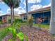 Charming backyard landscaping view with well-manicured shrubs and trees, highlighting the home's outdoor appeal at 16112 Amethyst Key Dr, Wimauma, FL 33598
