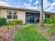 Beautiful backyard with lush greenery, mature palms, and a clear view of the screened-in lanai at 16112 Amethyst Key Dr, Wimauma, FL 33598