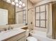 Bathroom features a vanity with a sink, a toilet, a mirror, and a shower tub combo at 16112 Amethyst Key Dr, Wimauma, FL 33598