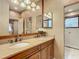 Elegant bathroom with a double vanity, granite countertop, and glass shower enclosure at 16112 Amethyst Key Dr, Wimauma, FL 33598