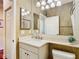 Bathroom features a vanity with sink and a toilet under a stylish lighting fixture at 16112 Amethyst Key Dr, Wimauma, FL 33598