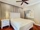 Comfortable bedroom featuring wood floors, a ceiling fan and a large mirrored closet at 16112 Amethyst Key Dr, Wimauma, FL 33598