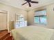 Cozy bedroom featuring hardwood floors, a window with blinds and a white dresser at 16112 Amethyst Key Dr, Wimauma, FL 33598