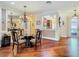 Dining room with hardwood floors and views through to kitchen area at 16112 Amethyst Key Dr, Wimauma, FL 33598