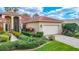 Charming single-story home with a well-manicured lawn and vibrant landscaping at 16112 Amethyst Key Dr, Wimauma, FL 33598