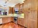 Spacious kitchen featuring wooden cabinets, stainless appliances, and hardwood flooring at 16112 Amethyst Key Dr, Wimauma, FL 33598