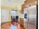 Kitchen area with breakfast nook, stainless refrigerator, and hardwood floors at 16112 Amethyst Key Dr, Wimauma, FL 33598