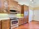 Kitchen with stainless steel appliances, shaker cabinets and hardwood floors at 16112 Amethyst Key Dr, Wimauma, FL 33598